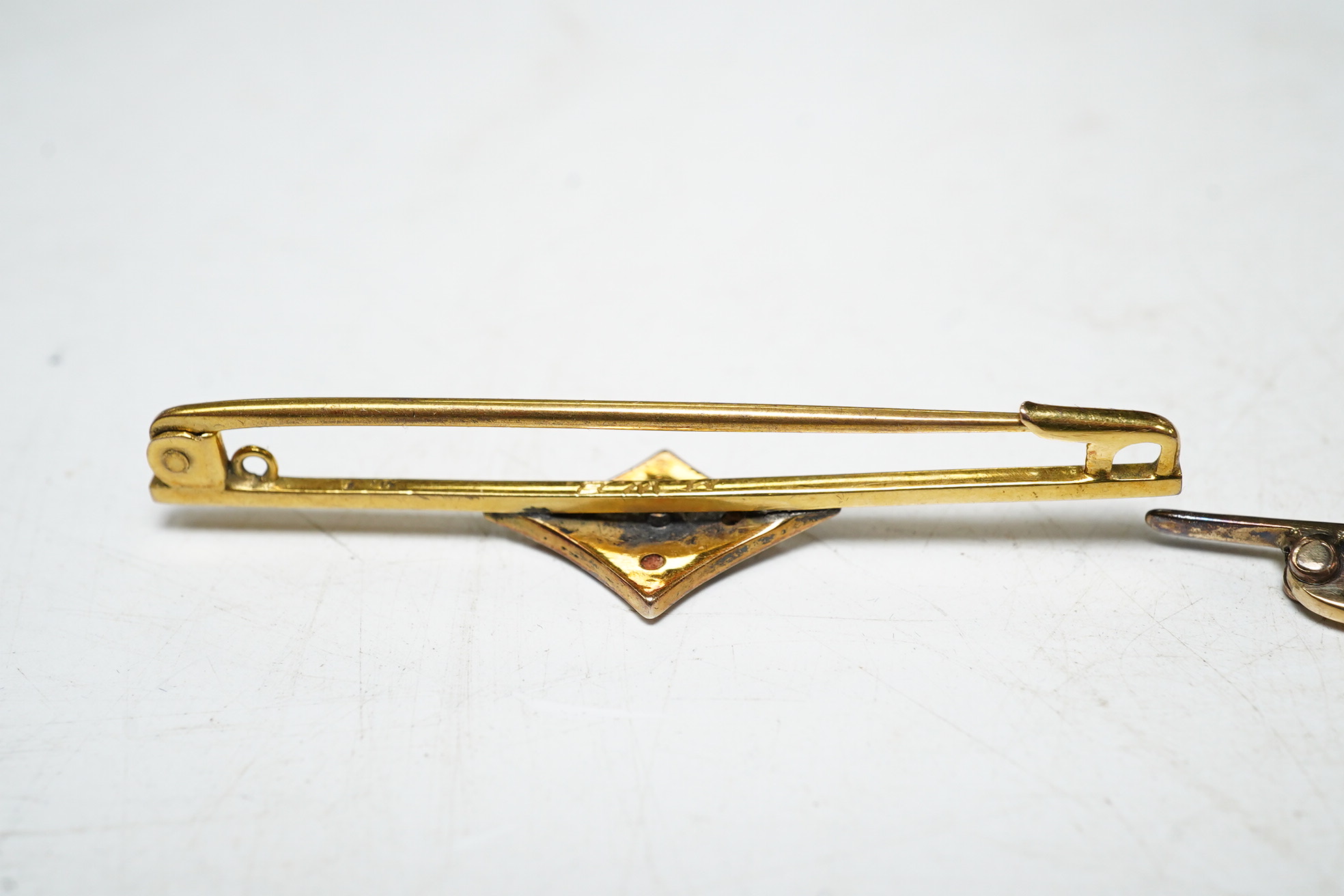 A 9ct gold split pearl and enamel set bar brooch, 1.9 grams, and a cased yellow metal pearl set bar brooch. Condition - good